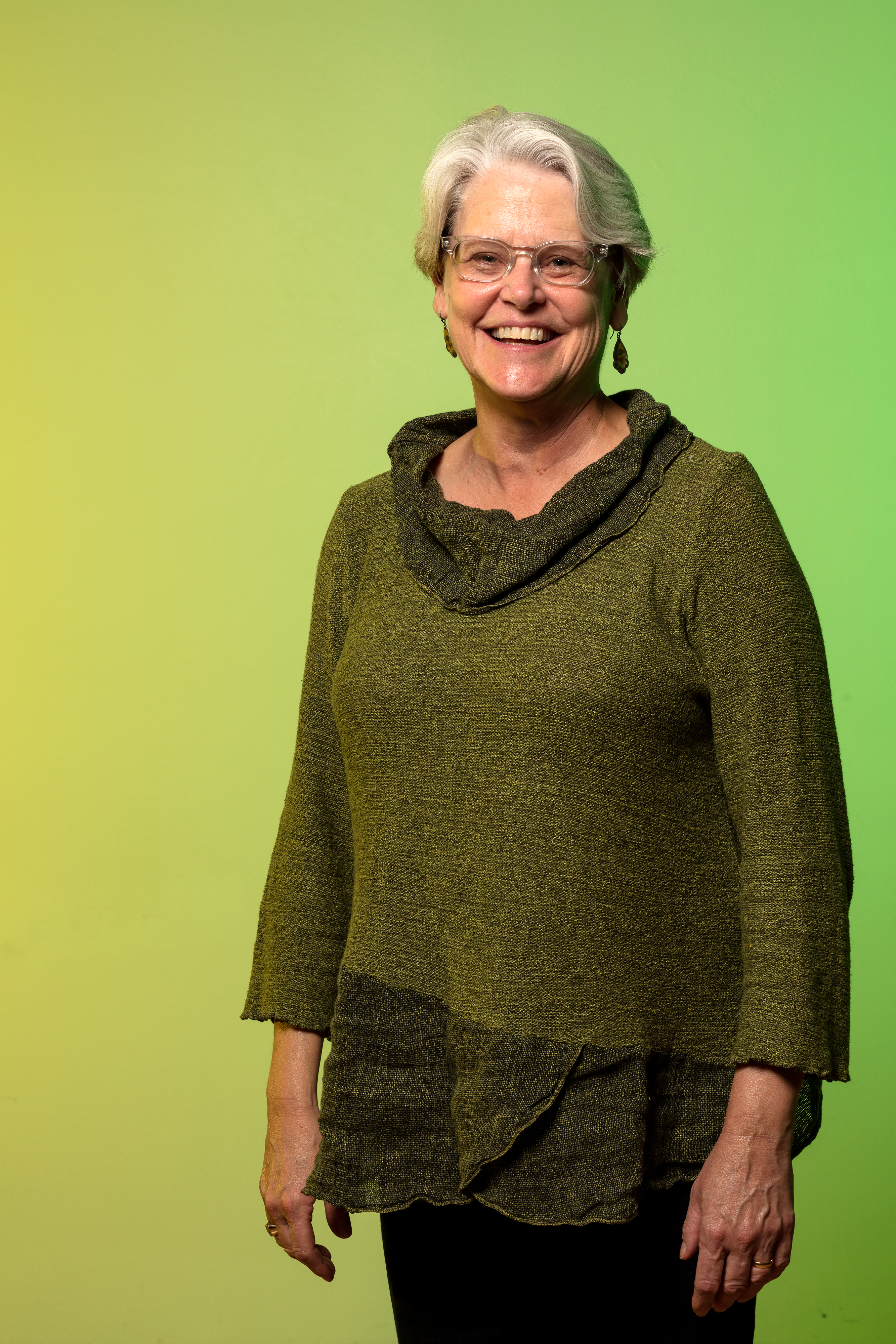 smiling woman against a bright green backdrop