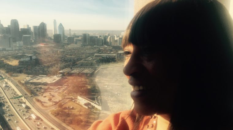Rhonda Butte posing in front of Dallas skyline